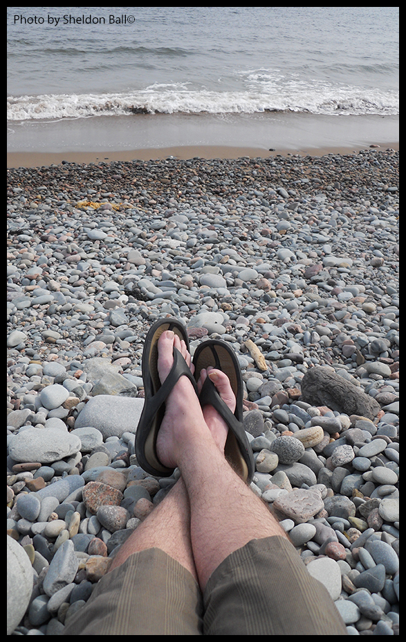 Picture of someone sitting by the ocean on the coast of Nova Scotia Canada - Photo by Sheldon Ball